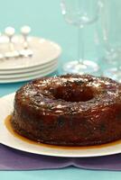 delicious raisin cake with caramel sauce on the table photo