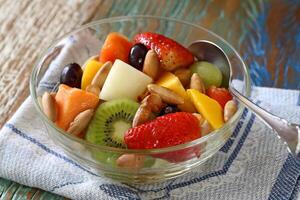 fruit salad with baru nuts in bowl photo