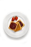 cream cracker with strawberry, grape and physalis jam on plate photo