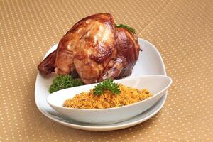 Roast chicken with farofa on plate on the table photo