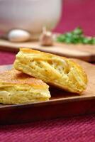 step by step of Tortilla de Patata, classic Spanish dish with eggs, potatoes, chopped chives and salt photo