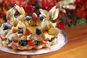 Vanilla tart with berries sprinkled with icing sugar photo