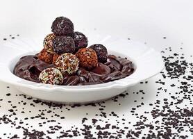 chocolate brigadeiro on plate with chocolate sprinkles photo