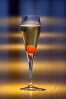 Champagne cocktail, light drink with a cube of sugar, cognac, angostura and brut champagne photo