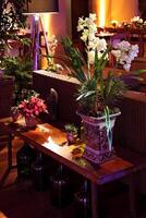 sophisticated party decoration with candles, flowers, tables and specialized lighting photo