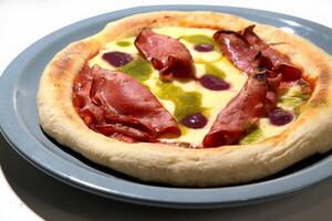 ham pizza with cheese, olives and pesto sauce photo