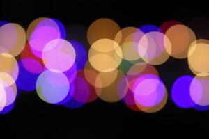 colorful and defocused lights on black background photo