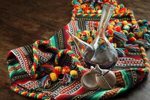 Blanket with porrones with wine and castanets on wooden table photo