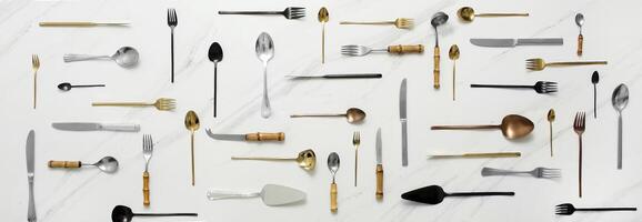 various cutlery on marble background in symmetrical assembly photo