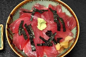 Tekka donburi, Japanese dish with rice topped with marinated tuna sashimi, soy sauce, mirim and chives photo