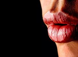 beautiful woman lips close up on black background photo