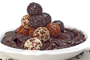 chocolate brigadeiro on plate with chocolate sprinkles photo