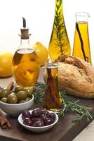 olive oil seasoned with orange, cinnamon and rosemary on wooden cutting board photo