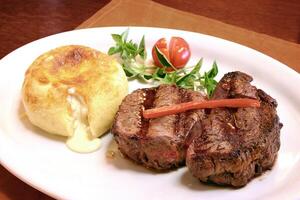 ancho steak with cheese bread with cream cheese on the plate photo