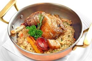 roast chicken with rice seasoned with bacon, herbs and sausage photo