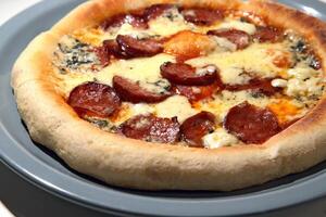 pepperoni pizza with roquefort cheese and tomato sauce photo