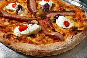 bacon pizza with cream cheese, cherry tomatoes and olives photo