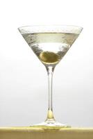 Vodka Martini, drink with vodka, dry martini and an olive in the glass photo