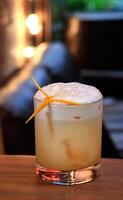 Smoky Whiskey Sour, delicious drink with scotch whiskey, lemon, maple syrup and angustura photo