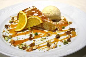 orange cake with ice cream and pistachio photo