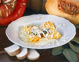 polenta with pumpkin in olive oil with pecorino cheese photo