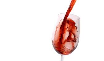 red wine being served in a glass on a white background photo