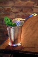 Mint Julep, drink with bourbon whiskey, sugar syrup and angustura photo