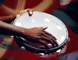 hands playing Brazilian batucada instruments in close-up photo