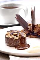 chocolate petit gateau with chocolate sauce on plate photo