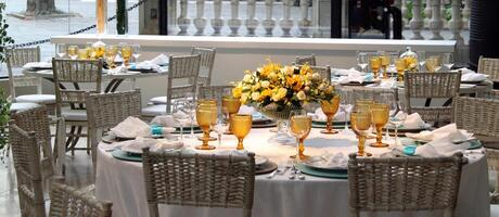 sophisticated lunch table setup in yacht club with plates, glasses, flowers and cutlery photo