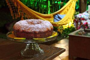 Orange cake with sugar on the table photo