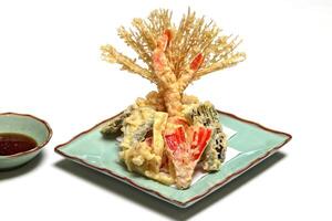 Shrimp and vegetable tempura, typical Japanese dish with breaded and fried shrimp and vegetables photo