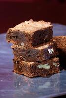chocolate brownies piled on plate photo