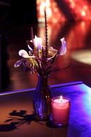 sophisticated party decoration with candles, flowers, tables and specialized lighting photo