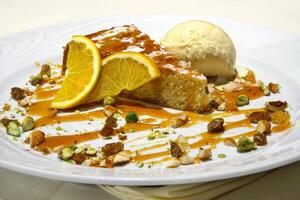 orange cake with ice cream and pistachio photo