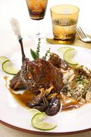 duck magret with rice and lemon on plate photo