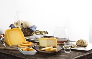 wooden table with snacks, fruits and cheeses to be tasted with pinga, the famous Brazilian brandy photo