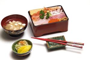 Tirashi, Japanese delicacy with salmon, squid, cucumber, nori, kani kama and salmon roe photo