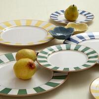 assembly of wooden cups, plates and platters with various fruits and vegetables seen from above photo