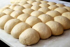 pizza dough resting on white marble table photo