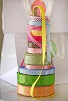 sample of materials, colors, dyes, fabrics and elements for the production of beautiful decorated wedding cakes photo