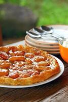 Tarte tartin with plates and cutlery on the table photo