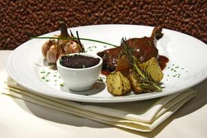 duck with garlic, potatoes and grape jelly photo