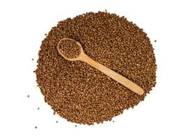 Dry buckwheat isolated on white background. Top view. Selective focus. photo