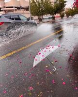 a car drives through a flooded street in the rain photo