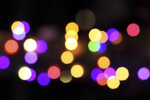 colorful and defocused lights on black background photo