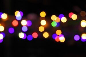 colorful and defocused lights on black background photo