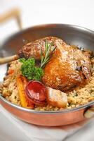 roast chicken with rice seasoned with bacon, herbs and sausage photo