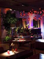 sophisticated party decoration with candles, flowers, tables and specialized lighting photo