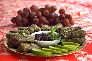 grape leaf cigars stuffed with meat accompanied by grape jelly photo